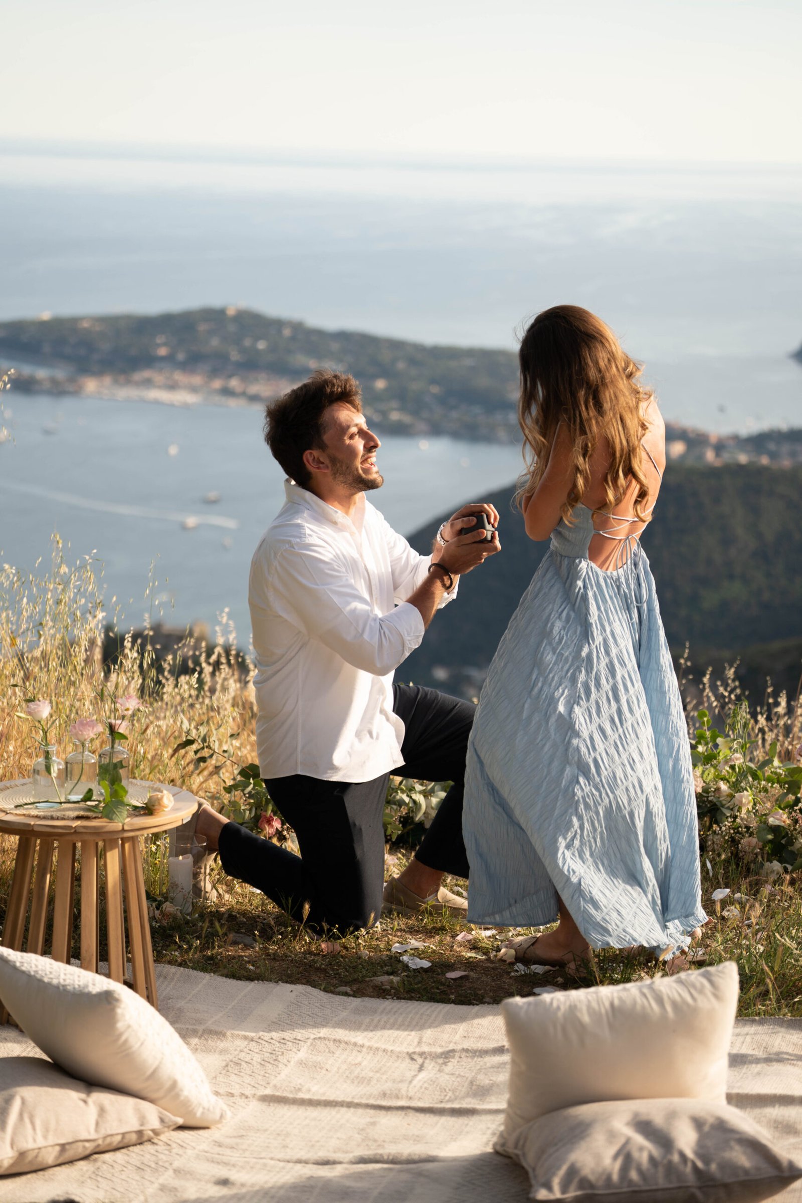 Romantic marriage proposal in Eze on the French Riviera overlooking the Mediterranean sea with floral decoration and panoramic view.
