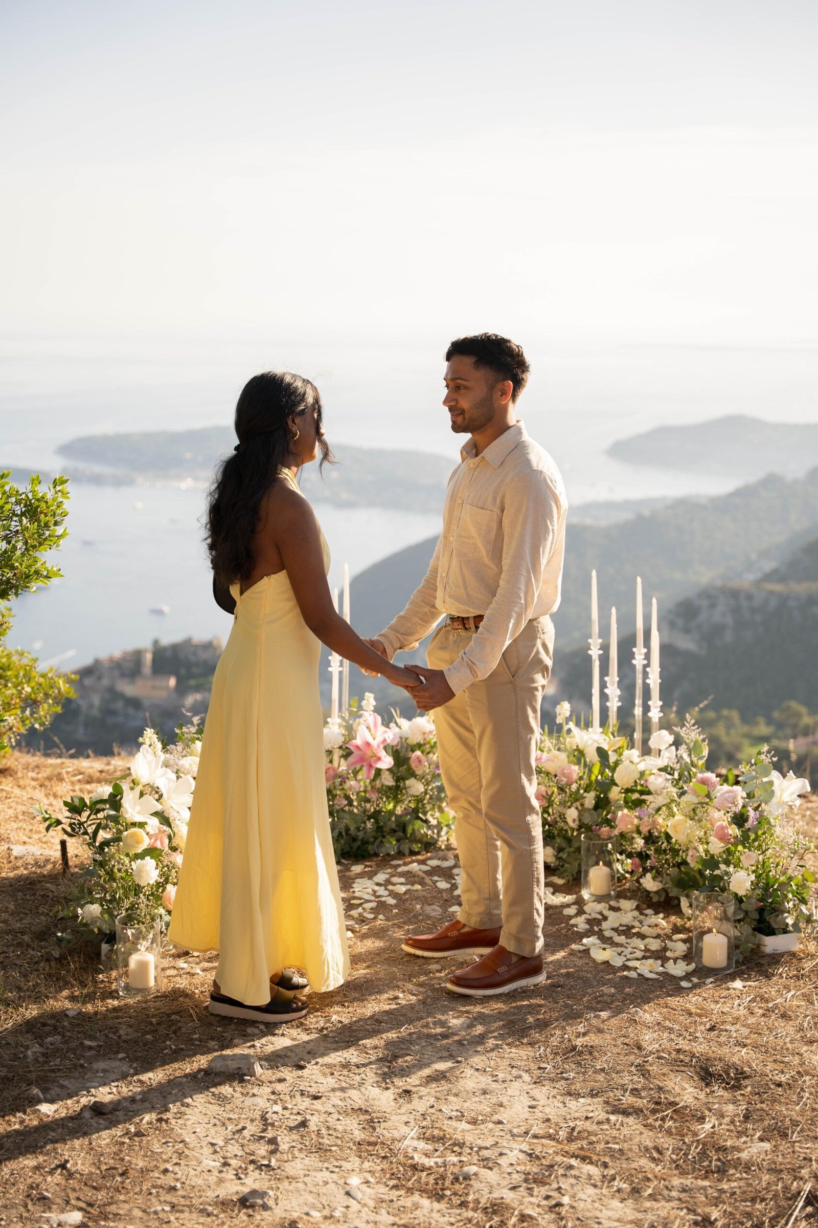 Romantic marriage proposal in Eze on the French Riviera overlooking the Mediterranean sea with floral decoration and panoramic view.